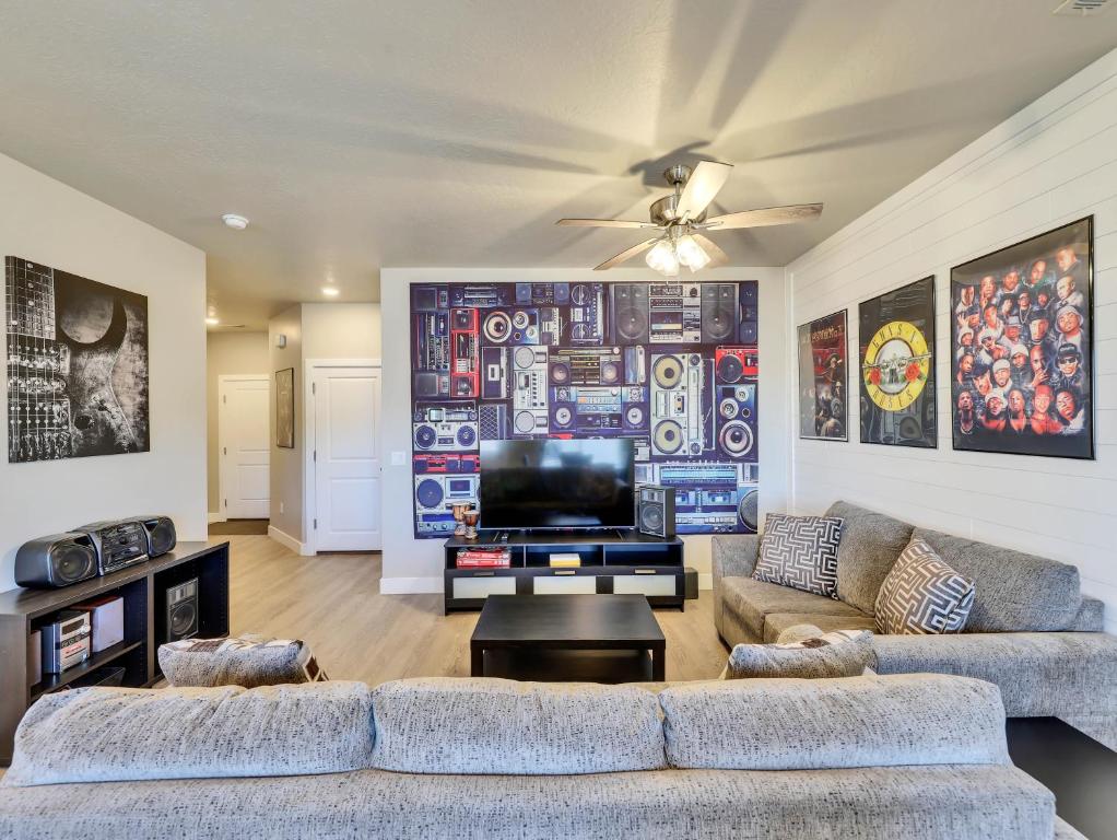 a living room with two couches and a flat screen tv at Band Camp Town Home in Cedar City