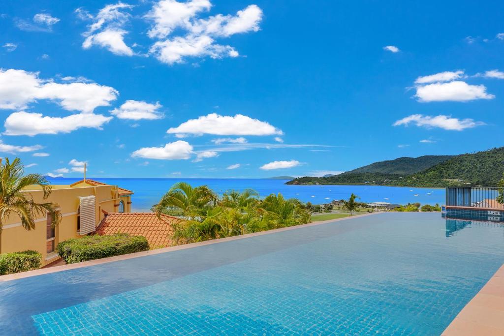 a swimming pool in a villa with a view of the ocean at Bella Paradiso in Airlie Beach