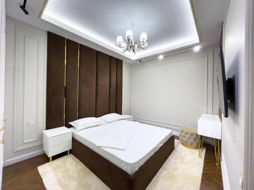a bedroom with a large white bed in a room at Modern Lux in Samarkand