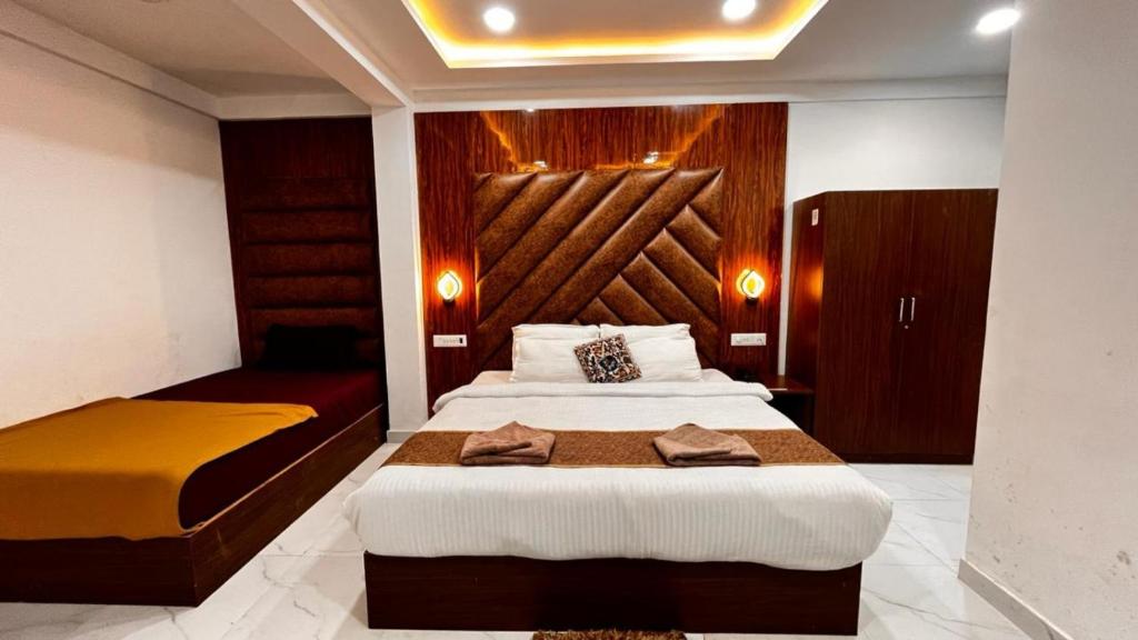 a bedroom with two beds with towels on them at Hotel Small Daddy Plus in Calangute