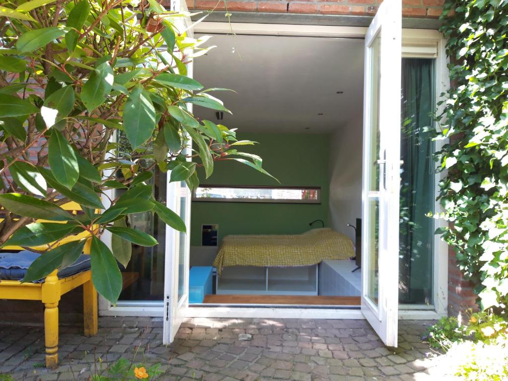 an open door to a bedroom with a bed in it at Sint Lambertusstraat in Eindhoven