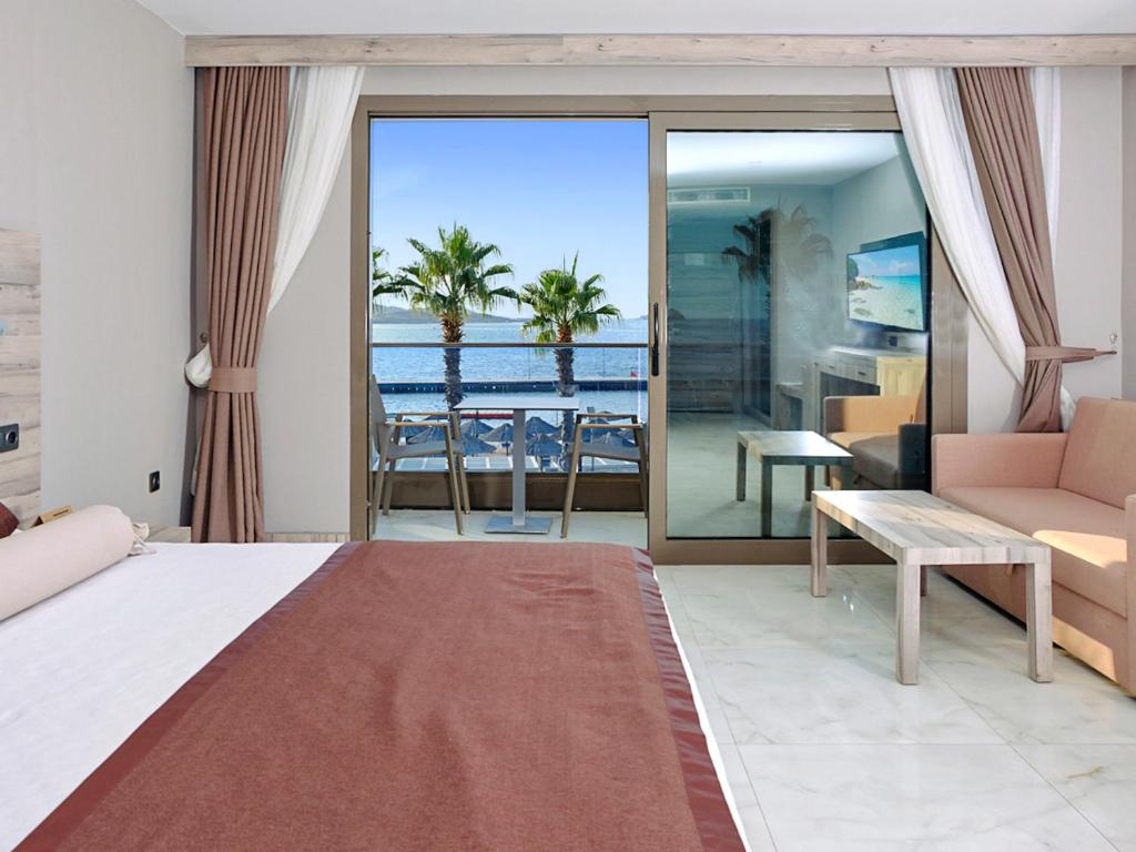 a bedroom with a bed and a view of the ocean at Delta Hotels By Marriott Bodrum in Yalıkavak