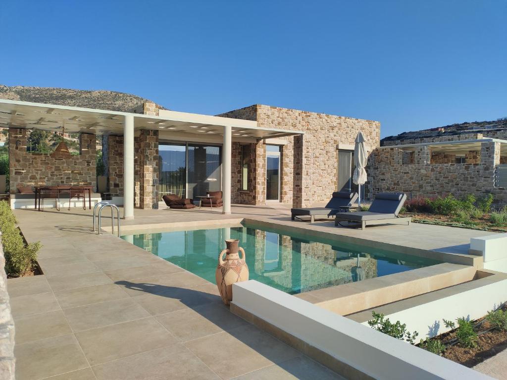 a house with a swimming pool in front of it at Orelia Luxury Villas in Amoopi