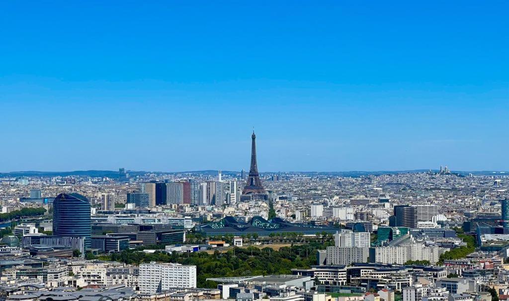 a view of a city with the eiffel tower at Full apt - Top floor - Eiffel Tower Panoramic View in Issy-les-Moulineaux