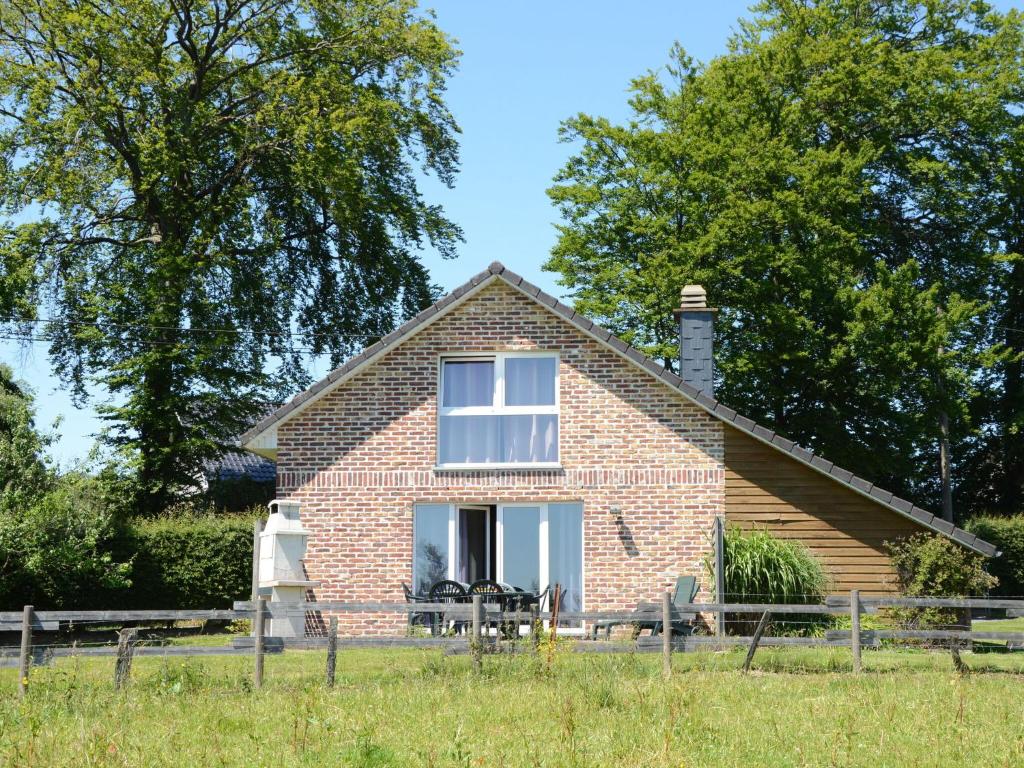 a brick house with a window in a field at Picture perfect Holiday Home in Sourbrodt with Garden BBQ in Sourbrodt