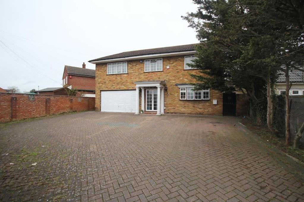 a brick house with a driveway in front of it at High Gable House -Four Bedrooms in Hillingdon