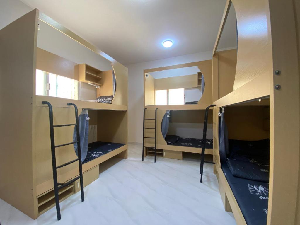 a room with two bunk beds and a room with mirrors at Loong shared book on web in Riyadh