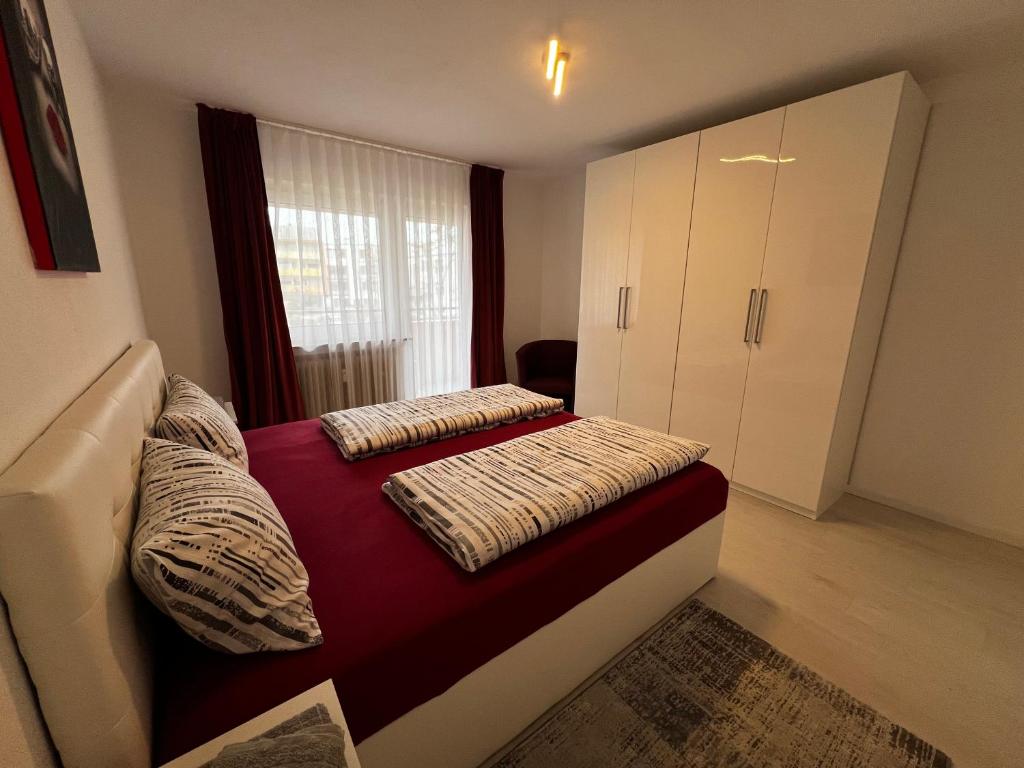 a bedroom with a bed with two pillows on it at Best Apartment Augsburg in Augsburg