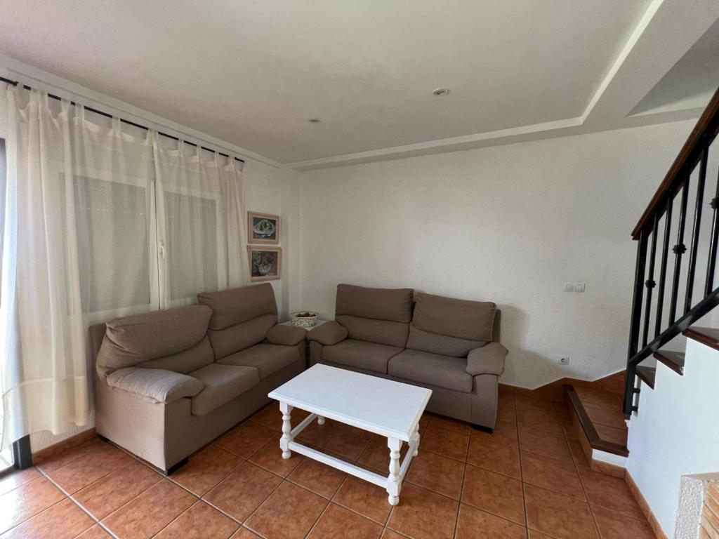a living room with a couch and a table at los hubios in Arroyo Frio