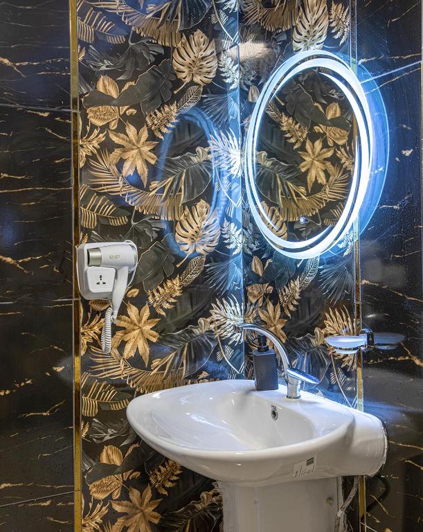 a bathroom with a sink and a mirror on a wall at Skyline Premium Properties in Alexandria