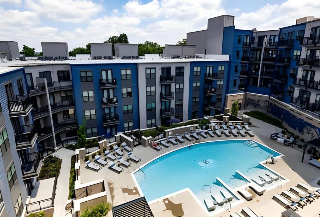 an aerial view of a building with a pool and chairs at Charming 2BR 2BA Retreat near Downtown Cincinnati in Cincinnati