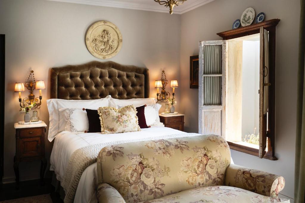 a bedroom with a large bed and a chair at Le Parc, Bryanston in Johannesburg