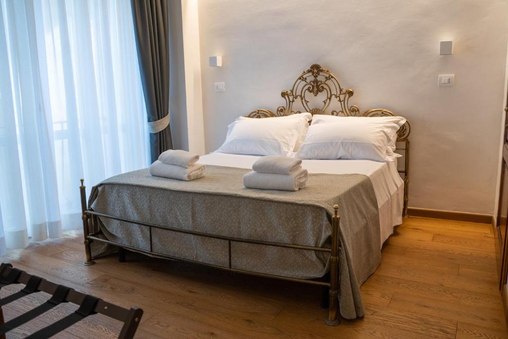 a bedroom with a large bed with towels on it at Residenza degli Speziali in Florence