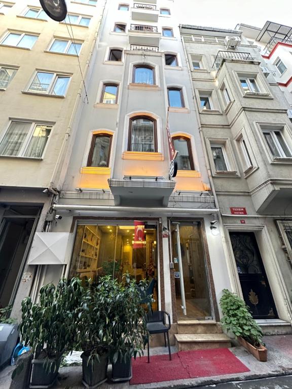 a facade of a building with plants in front of it at Alyon Suite Hotel Taksim in Istanbul