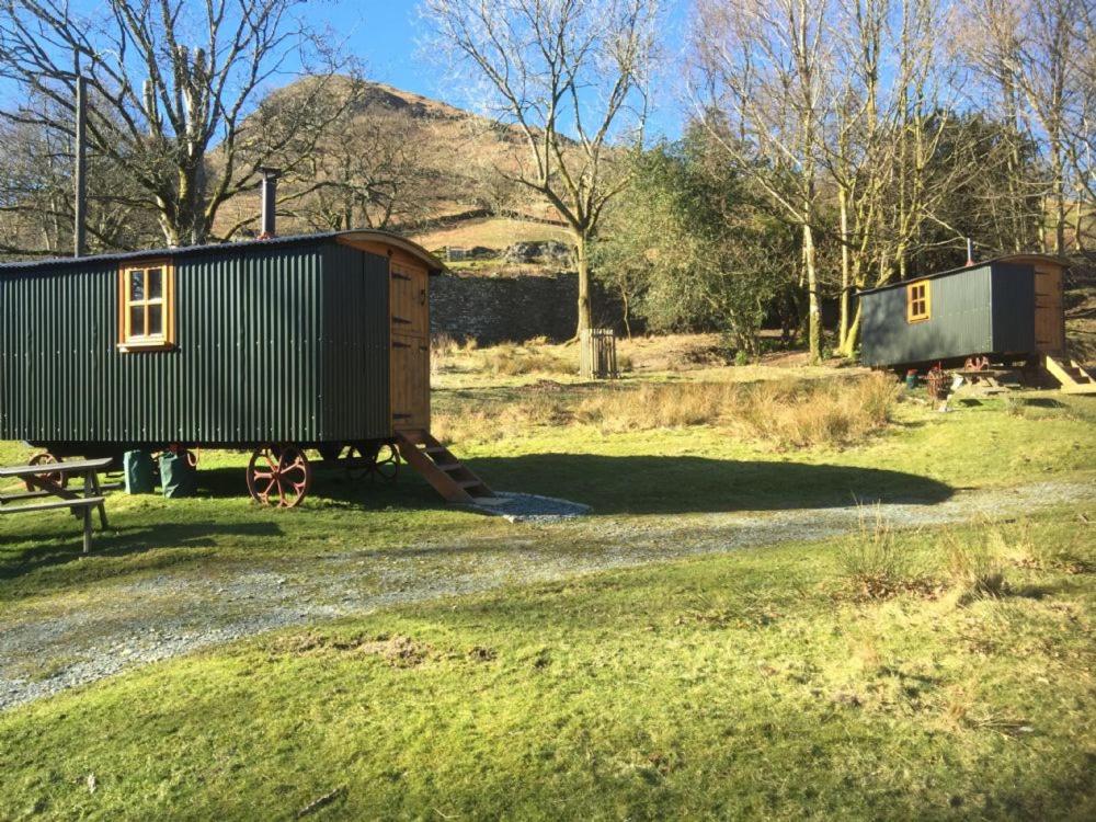 a train car sitting on the side of a road at Ghyll Shepherd's Hut in Rydal