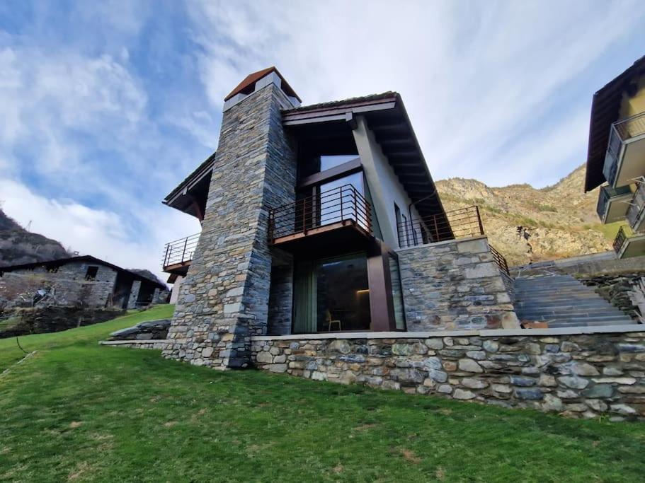 a stone house with a balcony on a hill at Little Paradise - Ampio Monolocale in Arvier