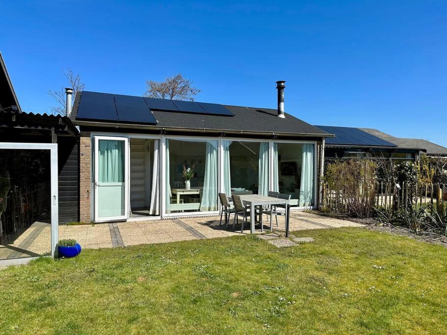 a house with a table and chairs in a yard at Boerenslag 41 in Sint Maartensvlotbrug