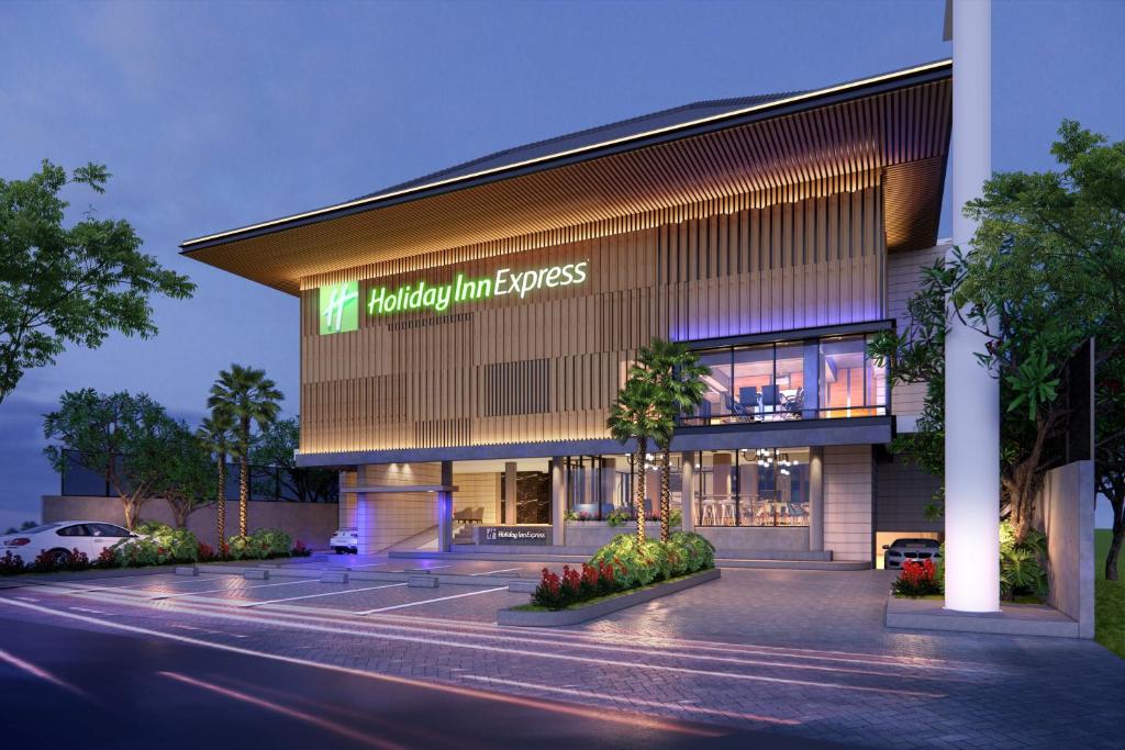 a building with a sign on the front of it at Holiday Inn Express Bali Sunset Road, an IHG Hotel in Legian