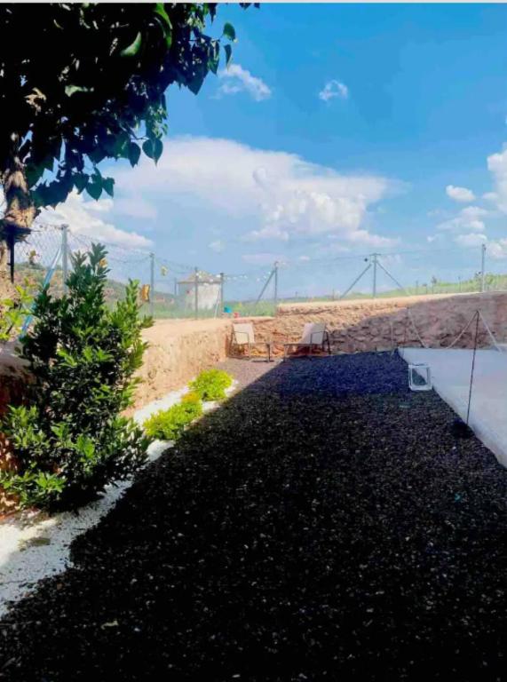 a garden with a view of the desert with a bench at Casa De La Era in Cuevas de Ayllón