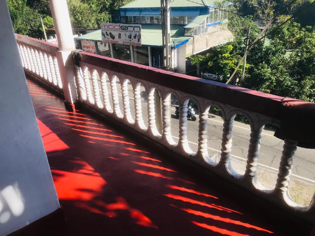 a white railing on a bridge over a street at Kandy Mount View hotel in Peradeniya