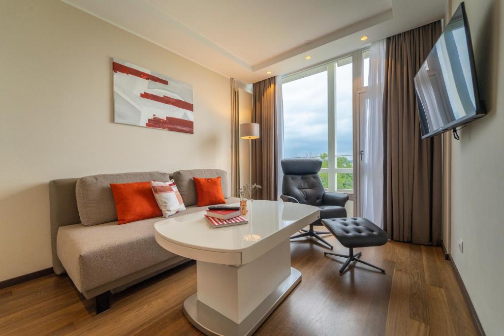 a living room with a couch and a table at Pakat Residences in Vienna