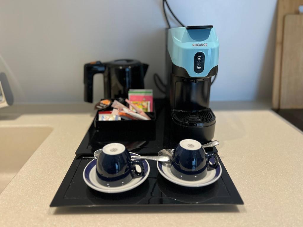 a black tray with two cups and a coffee maker at Pakat Residences in Vienna