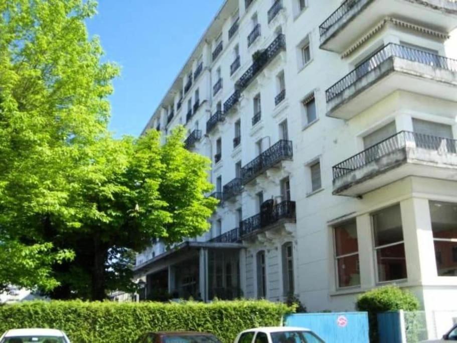 a white building with balconies on the side of it at Studio avec piscine, Vue lac et montagne in Aix-les-Bains
