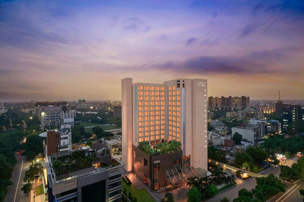 a tall building in a city at night at Hyatt Regency Lucknow Gomti Nagar in Lucknow