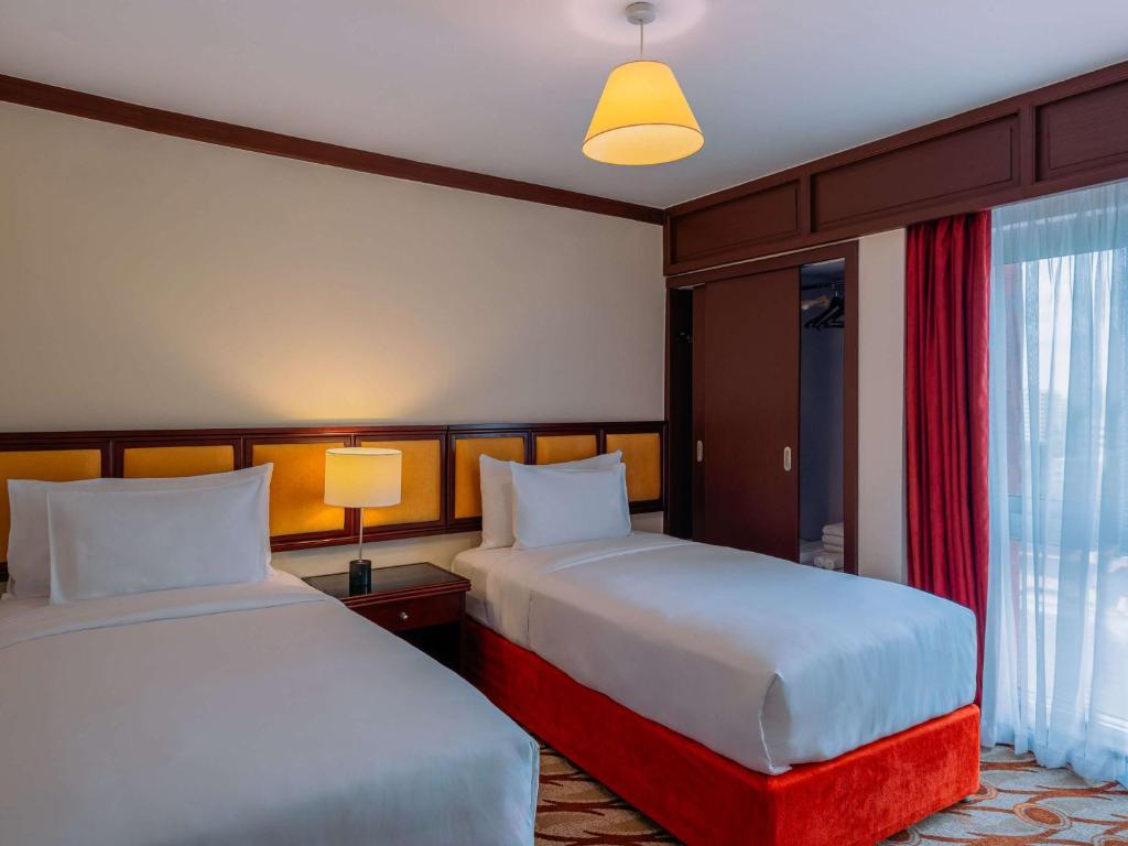 Postel nebo postele na pokoji v ubytování Mövenpick Hotel & Residences Nairobi