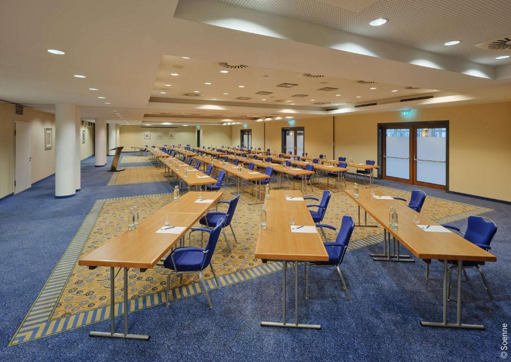 a large room with tables and chairs in it at Dorint Hotel Bonn in Bonn