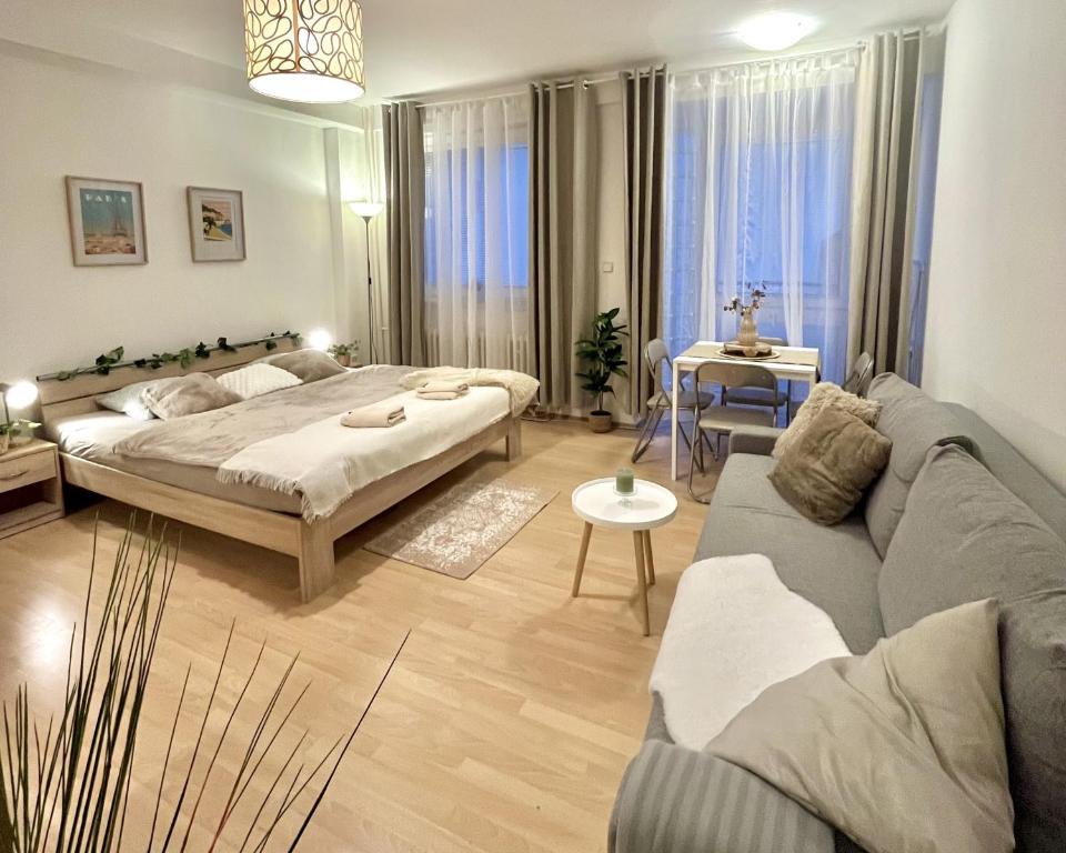a living room with a bed and a couch at Apartment Simona - Old Town in Bratislava