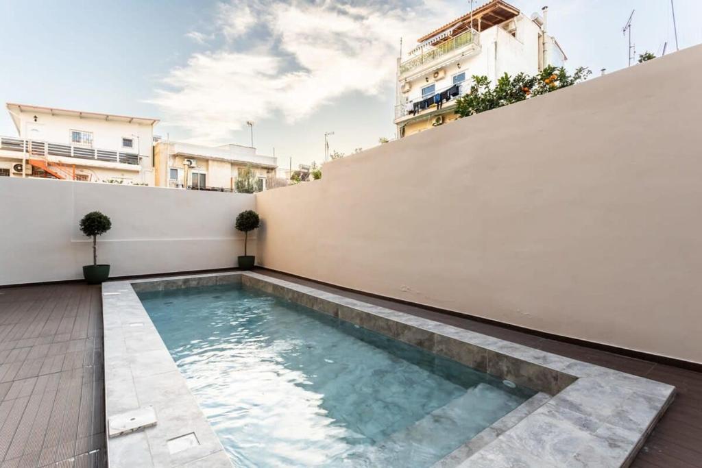 a swimming pool on the roof of a house at Athens Grec Suites - The Ultimate City Getaways In Dafni in Athens