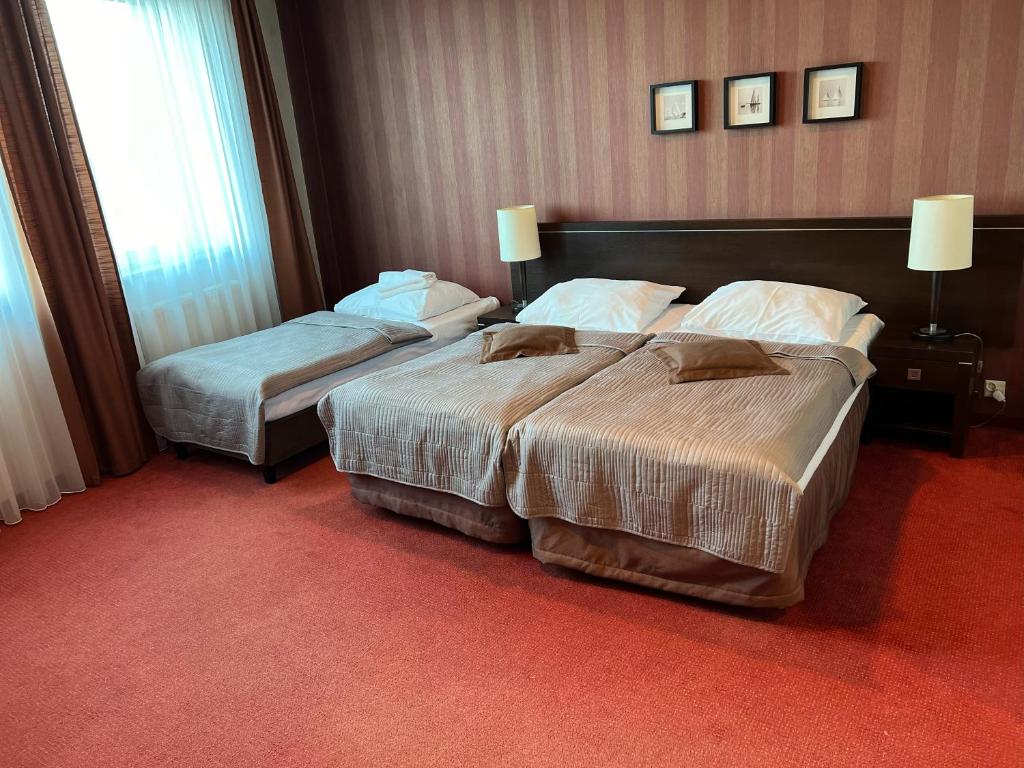 Postel nebo postele na pokoji v ubytování Hotel Pik