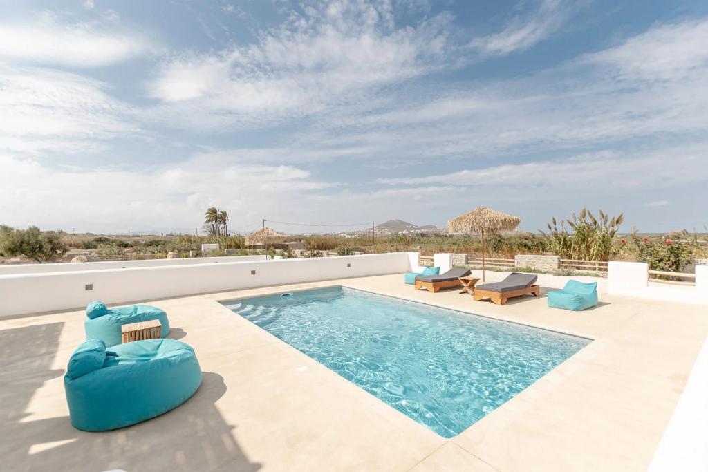 a swimming pool on the roof of a house at Gorgeous Naxos Villa | 3 Bedrooms | Villa Hancock | Beautiful Sea Views and Private Pool | Naxos in Agia Anna Naxos