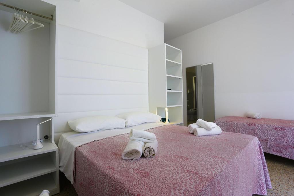 Postel nebo postele na pokoji v ubytování Hotel Ninfea Cattolica