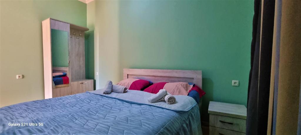 - une chambre avec un lit et une couette bleue dans l'établissement Rita Gujejiani Guesthouse, 