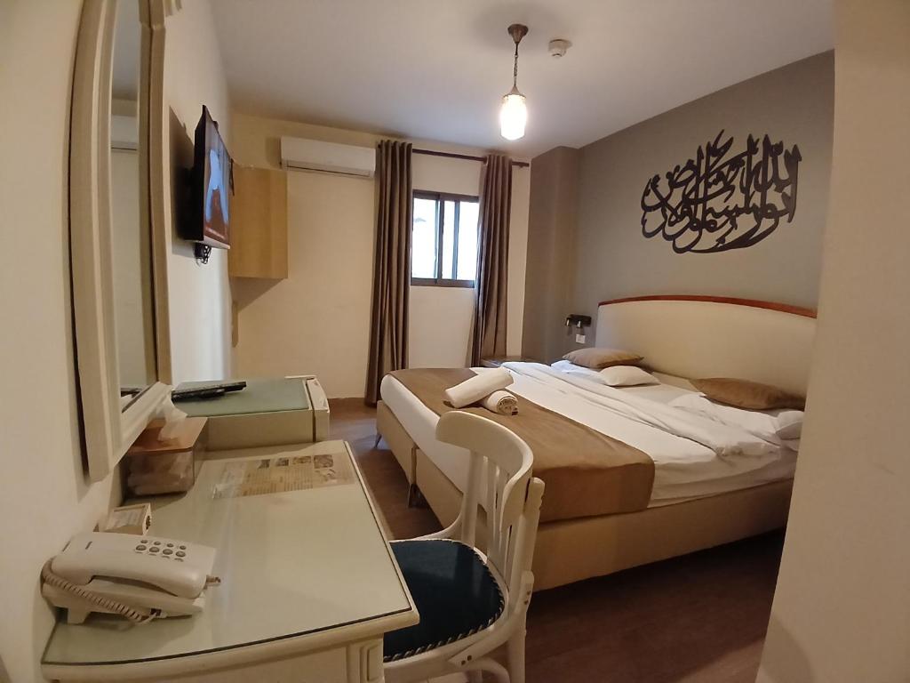 una camera d'albergo con due letti e un tavolo di Layaali Amman Hotel ad Amman