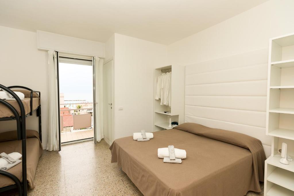 Postel nebo postele na pokoji v ubytování Hotel Ninfea Cattolica