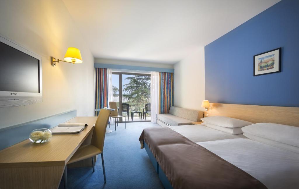 Krevet ili kreveti u jedinici u okviru objekta Remisens Hotel LUCIJA