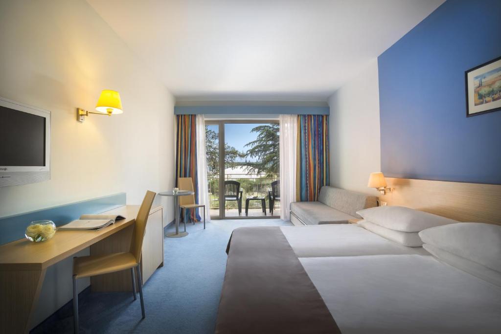 Krevet ili kreveti u jedinici u okviru objekta Remisens Hotel LUCIJA