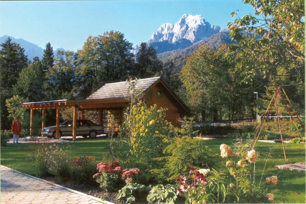 a cabin with a mountain in the background at Apartment Jakelj in Kranjska Gora