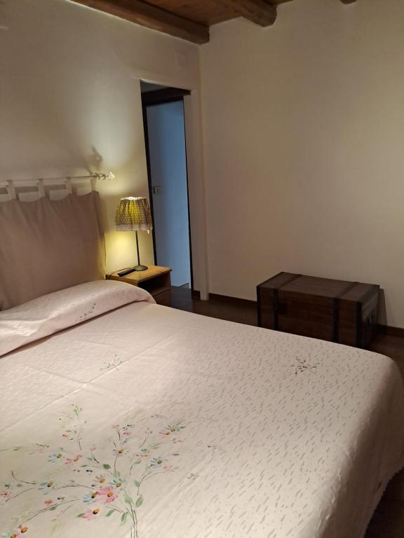 a bedroom with a bed with a white bedspread at A Casa dei Nonni in Frascati