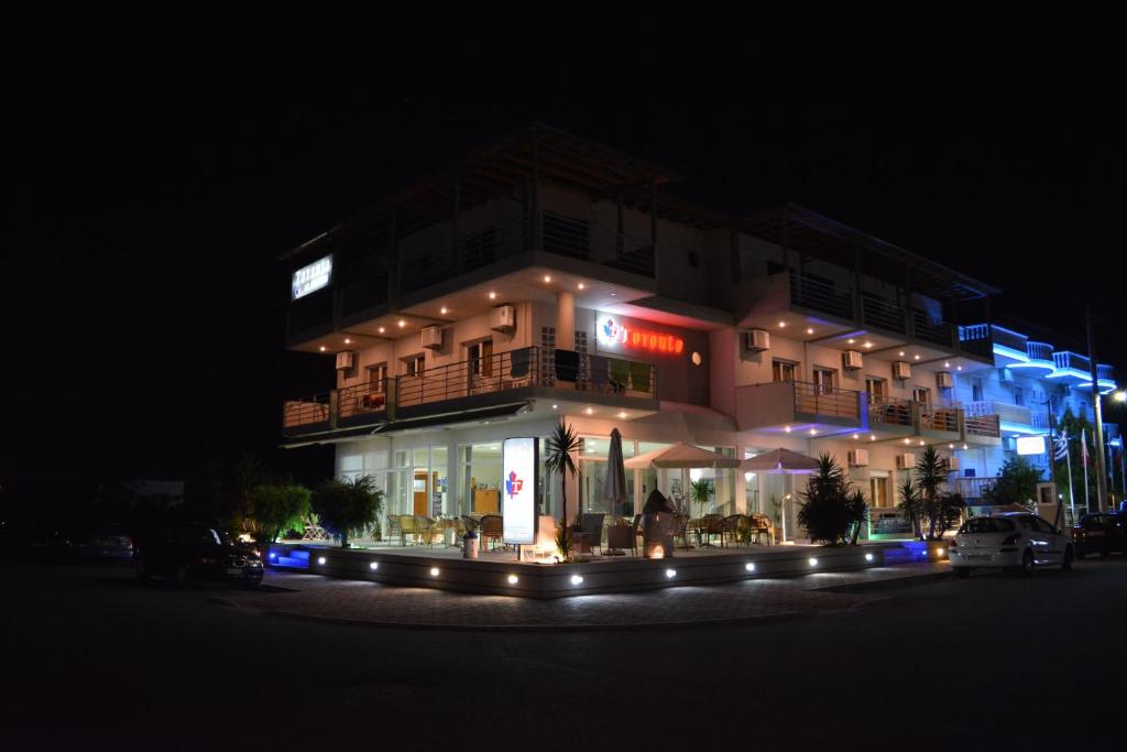a building at night with a car parked in front of it at Hotel Toronto in Paralia Katerinis
