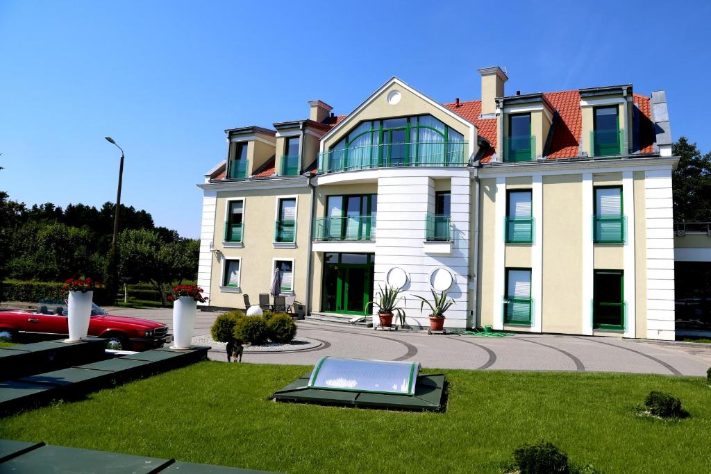 a large house with a laptop in the grass at Pokoje na Cyplu in Mrągowo