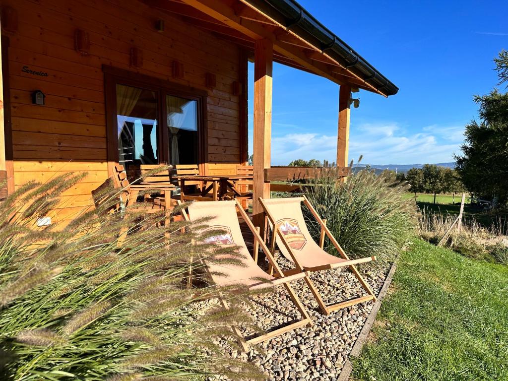 two chairs sitting on the porch of a cabin at Osada Karkonoska in Kowary