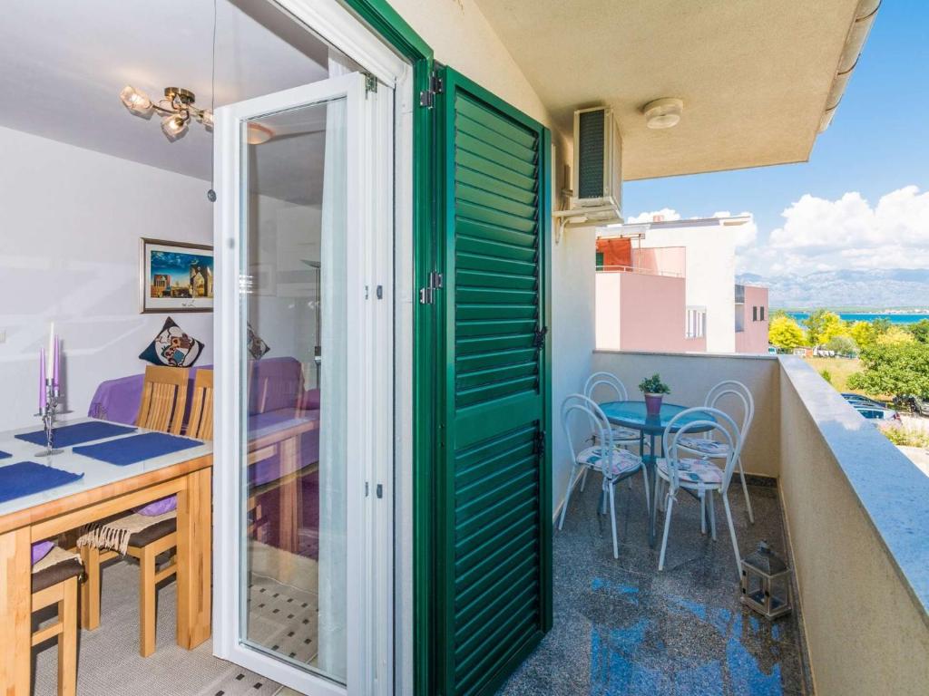 a room with a balcony with a table and chairs at New! Apartment Aenona 200m from the beach, Nin in Nin