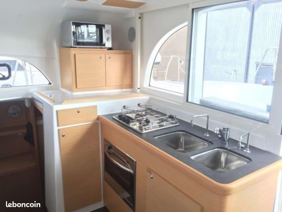 a kitchen with a sink and a stove and a window at Cristal de Mer - Cannes in Cannes