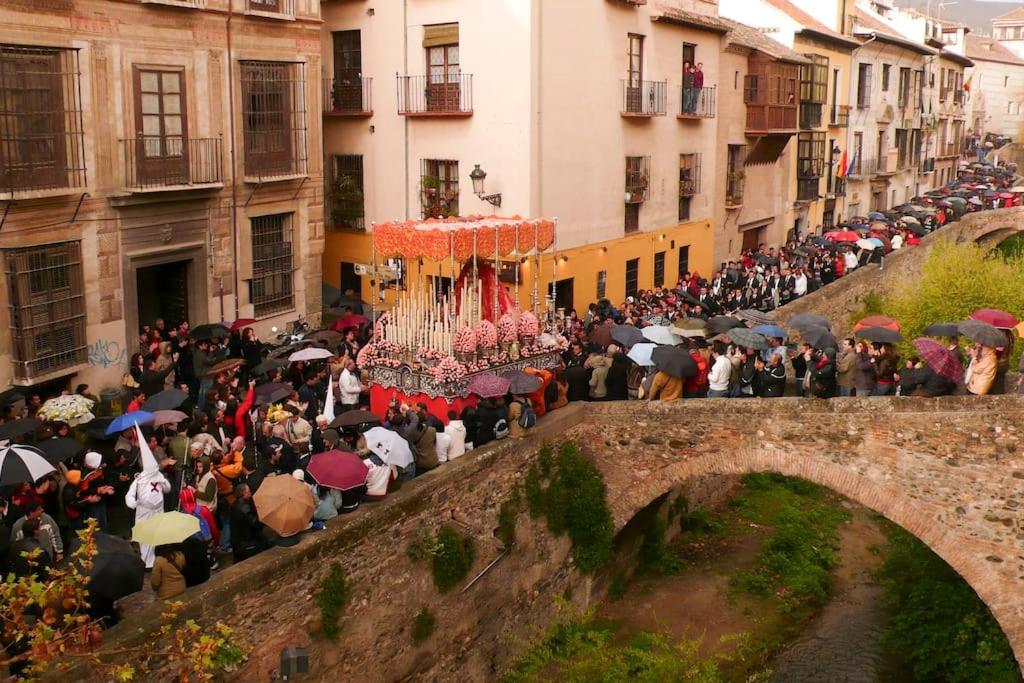 een menigte mensen met paraplu's op een brug bij Bonito duplex bajo Alhambra in Granada