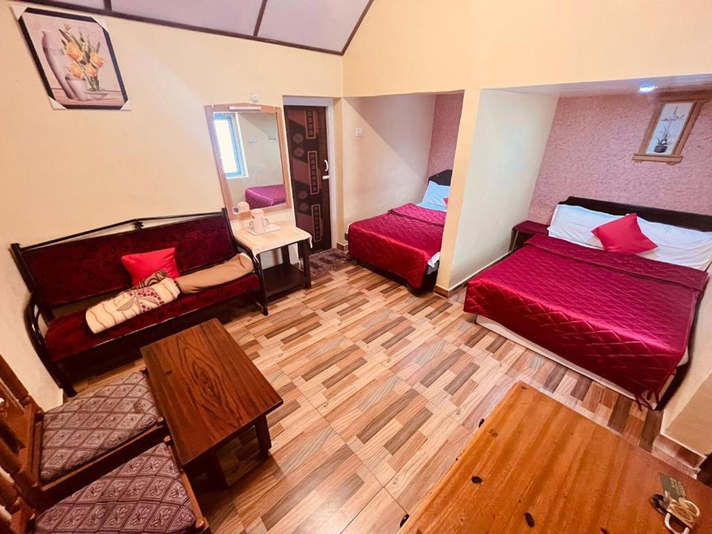 a living room with two beds and a mirror at Brickhouse in Kodaikānāl
