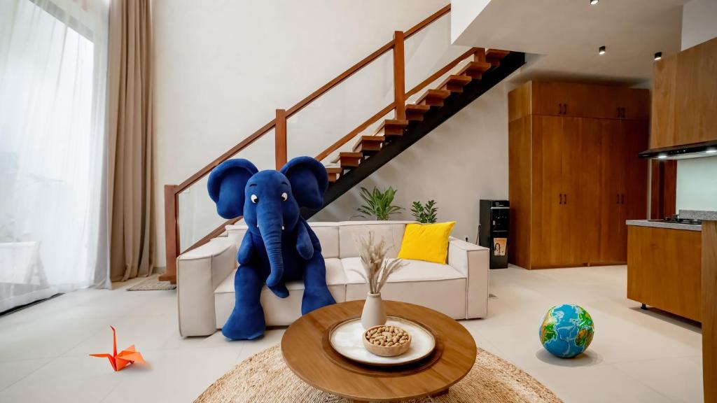 a living room with a large blue elephant in the middle at Sunny Cuddles in Canggu
